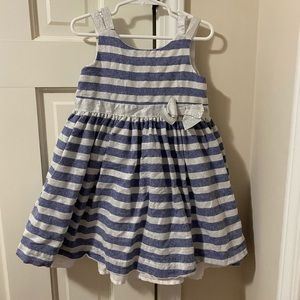 Stripe dress with silver accent bow and arm straps. Lovely buttons in the back.